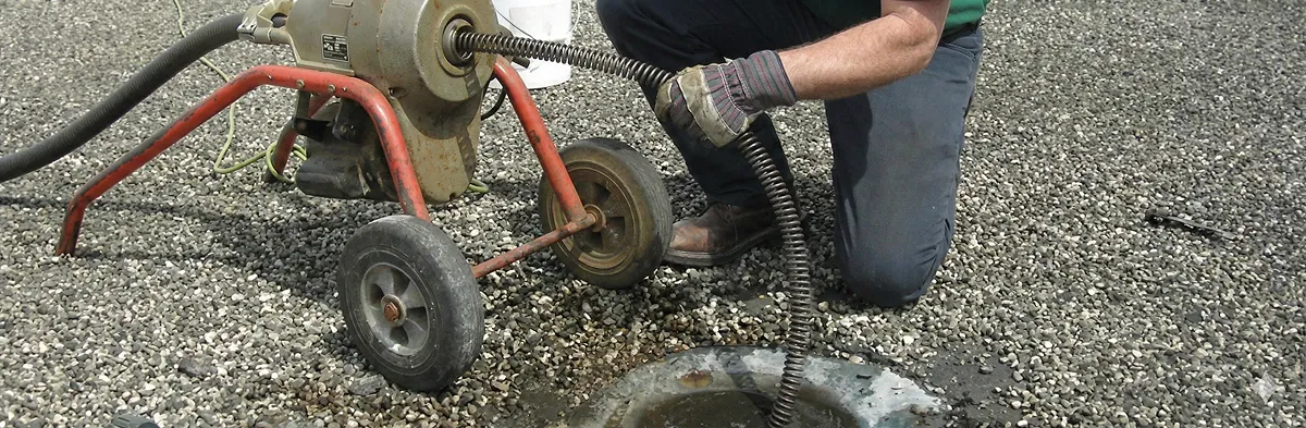 sewer rodding technician actively removing blockages from a sewer line in Erie, PA